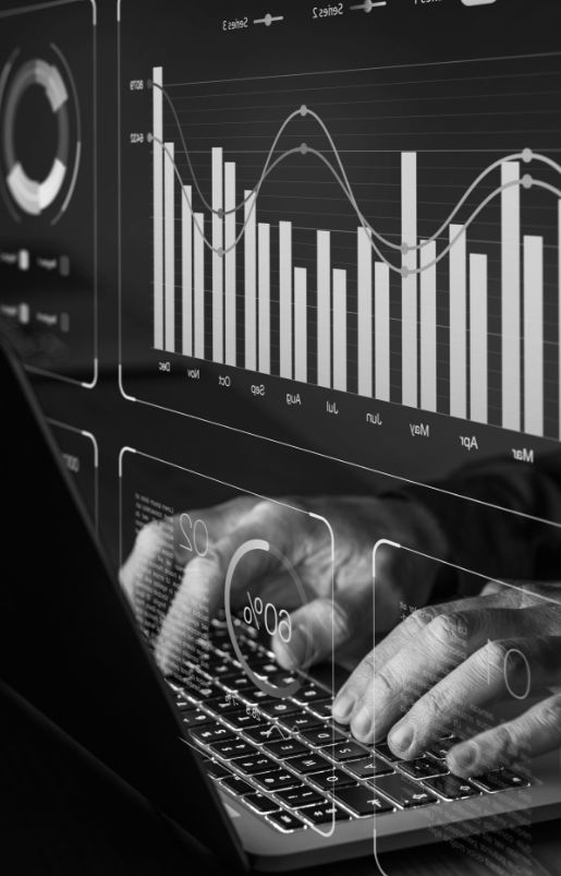 Digital graphs overlayed a persons hands and laptop