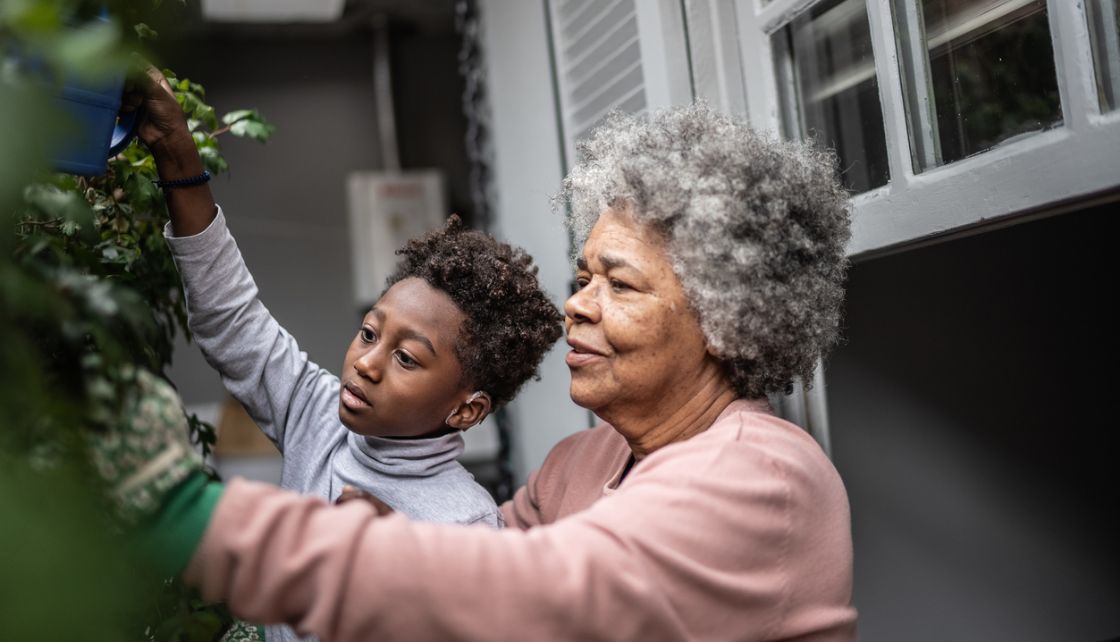 Grandmother and grandson working in the garden together