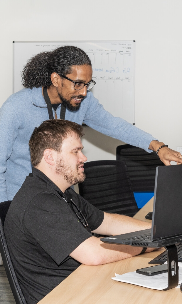 Office with multiple people working together on computers