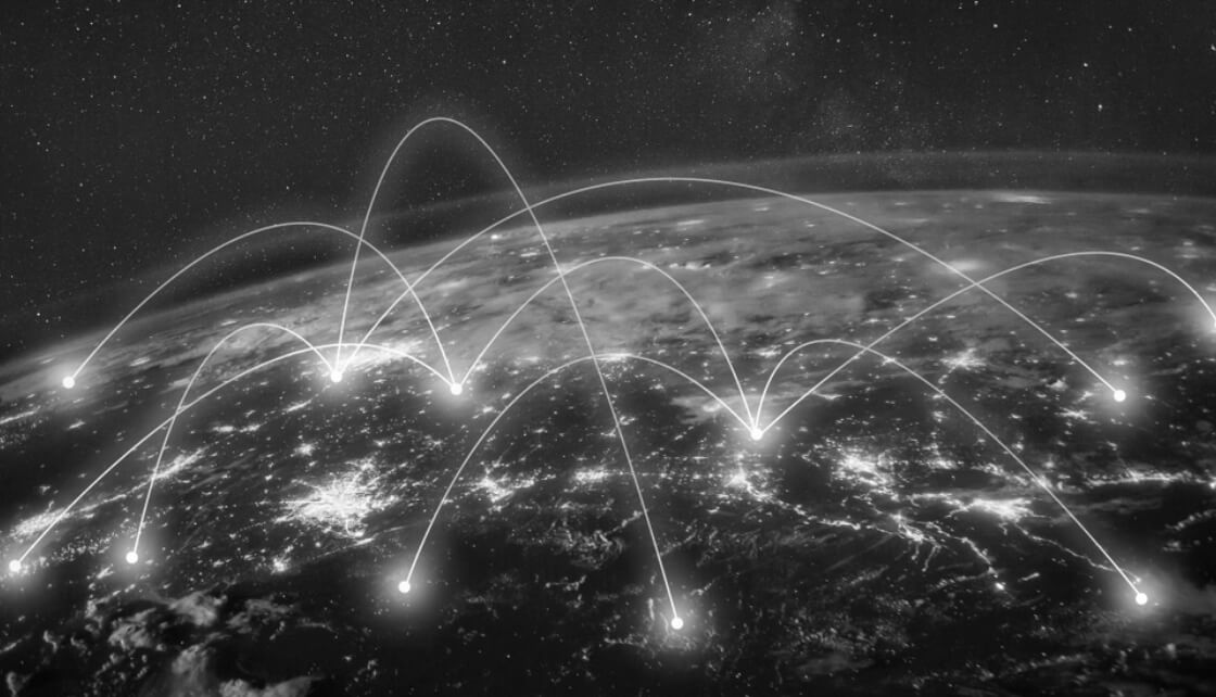 Satellite view of earth with illustrated glowing lines connecting different points on the globe